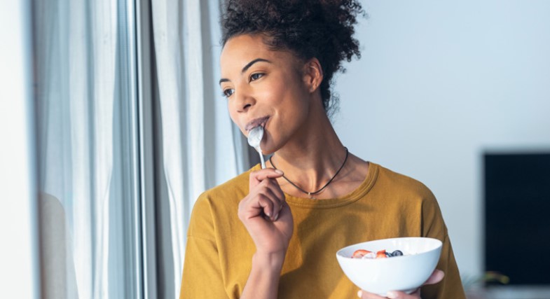 Diabetes Symptoms to diabetes management. black women looking out window with health food in hand