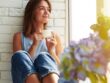 diabetes stress management. women leaning against wall drink in tea.